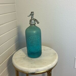 Two sided turquoise blue seltzer bottle 
Zion Bottling Co. & Kelly’s Beverages